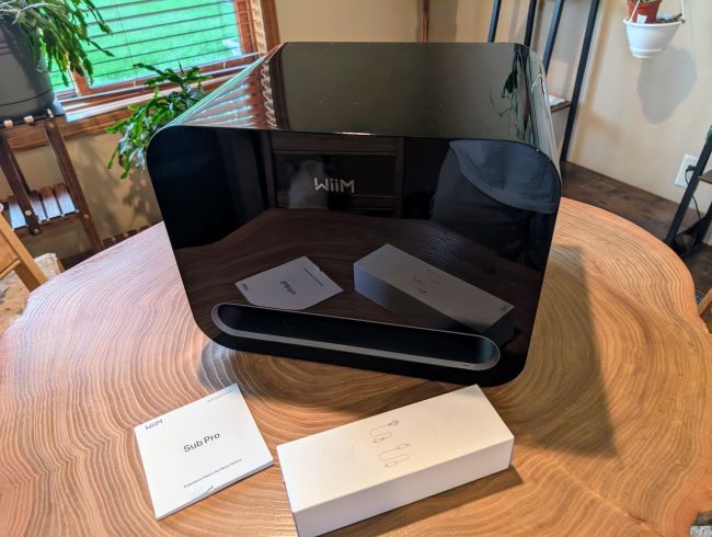 The WiiM Sub Pro sitting on a table for display